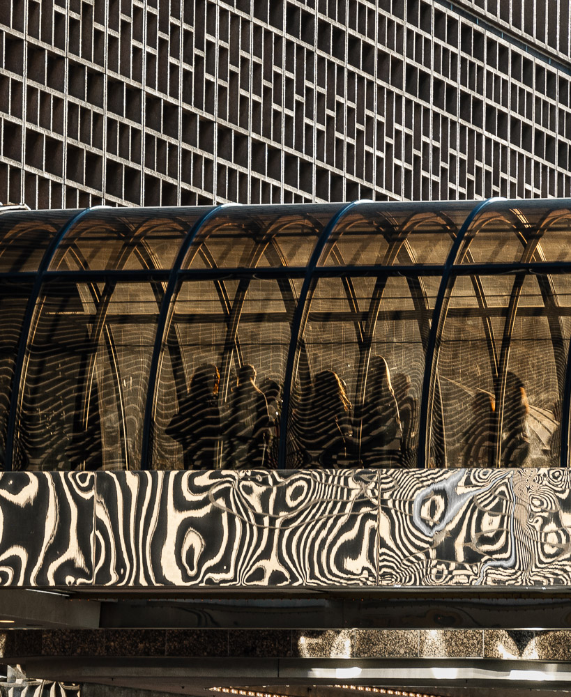 Patterns, lines, chaos, wonder. People going through.