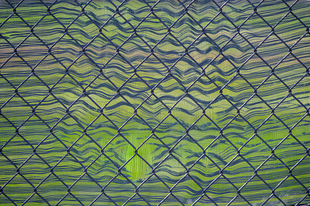 Chain link fence with frayed cloth